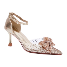 Ženske štikle ukrašene impresivnom zlatnom mašnom zlatni