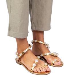 Zlatne ženske sandale ukrašene biserima zlatni